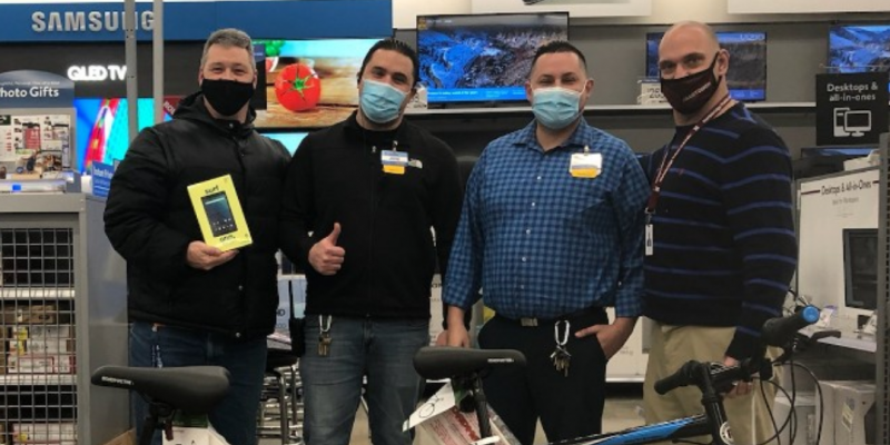 Picture of four people with Walmart Donations